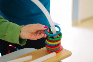 A woman uses physical therapy equipment at a skilled nursing facility